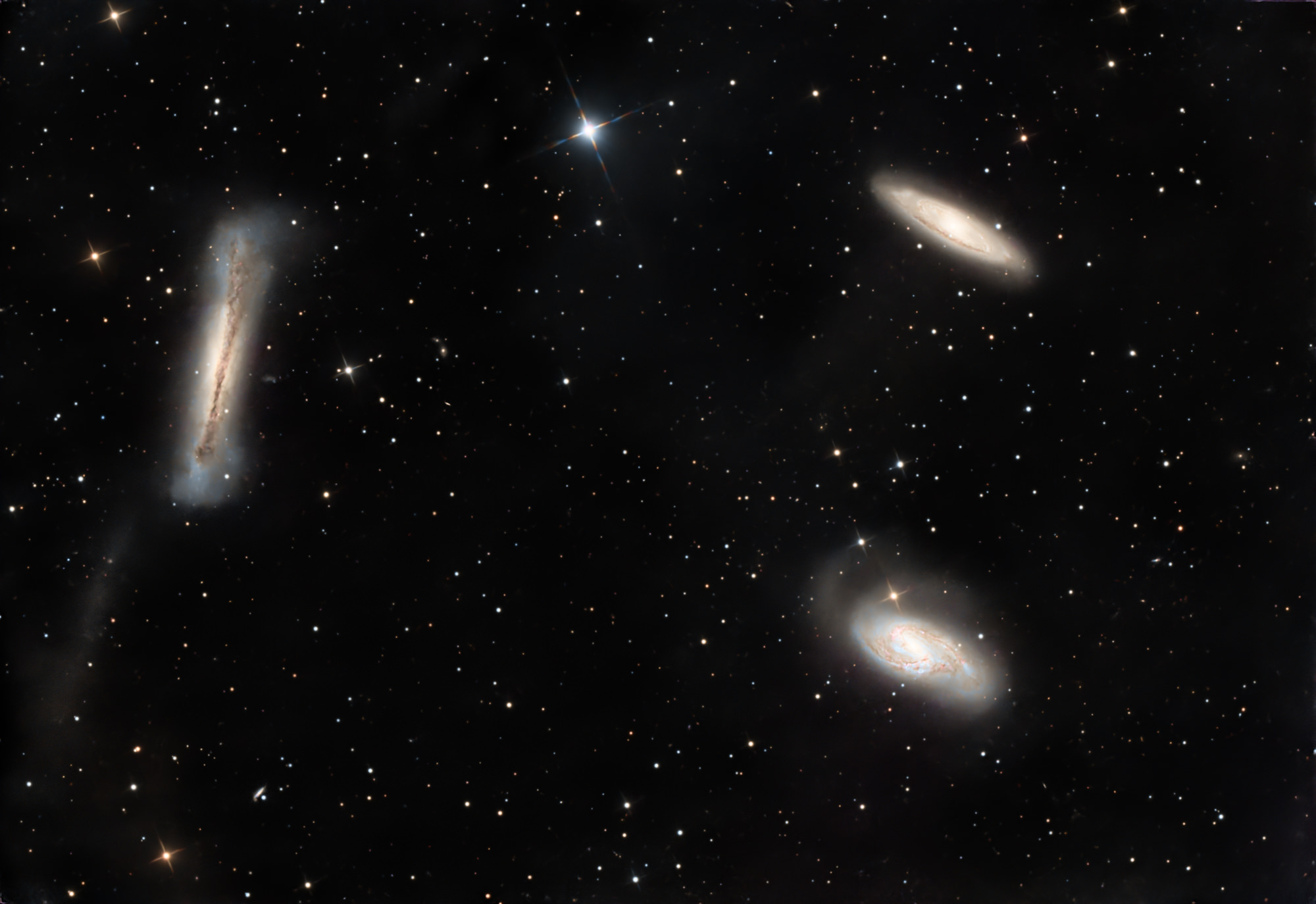 The Leo Triplet (also known as the M66 Group) is a small group of galaxies about 35 million light-years away in the constellation Leo. This galaxy group consists of the spiral galaxies M65, M66, and NGC 3628.
